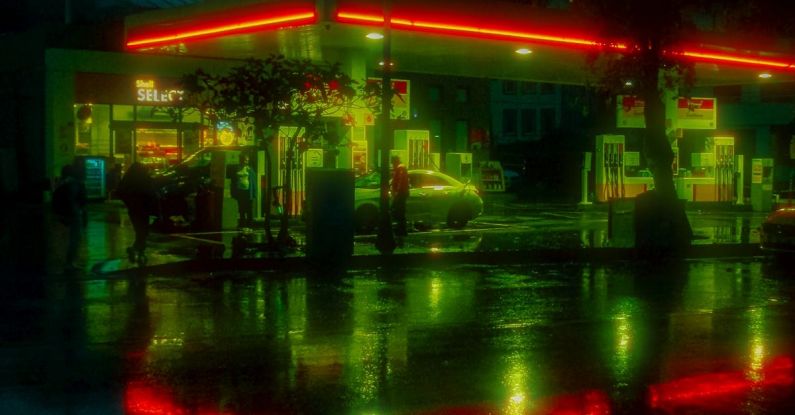 Fuel Pump - A gas station lit up at night with green lights