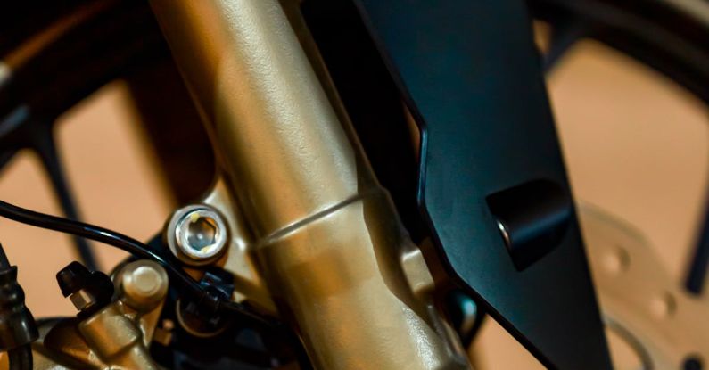 Brake Rotors - Closeup of modern motorbike wheel with brake panel and fork tube fixed with screws