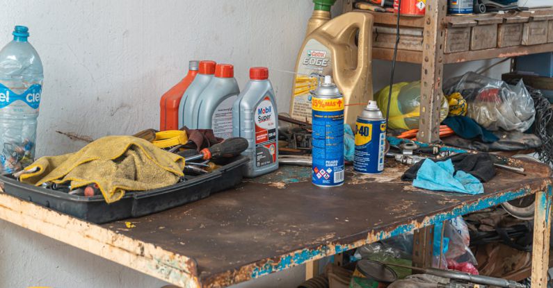 Oil Changes - Automotive Oil Containers On A Rusty Table