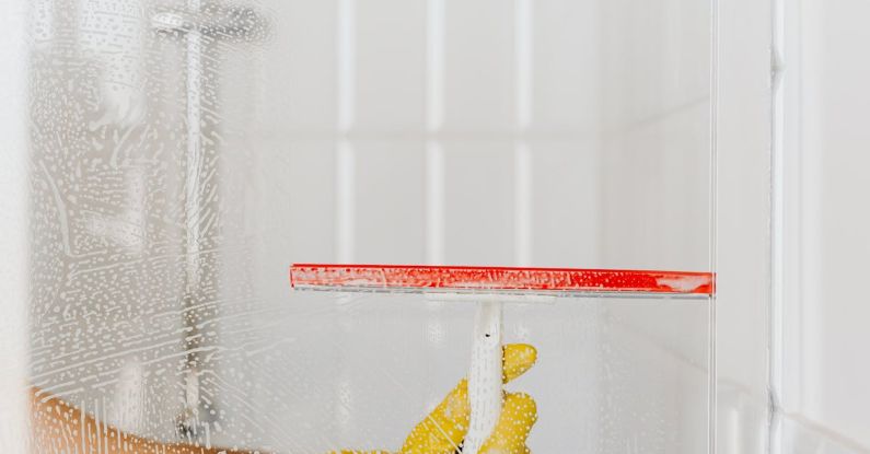 Wiper Blades - Crop person cleaning glass shower unit