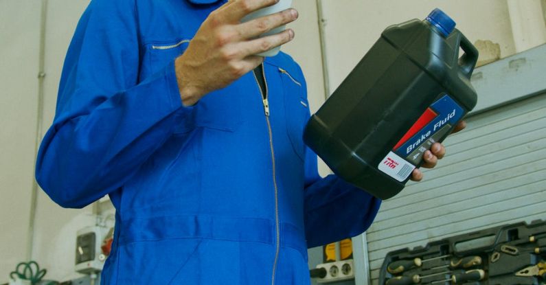 Brake Fluid - A Man using a Smartphone