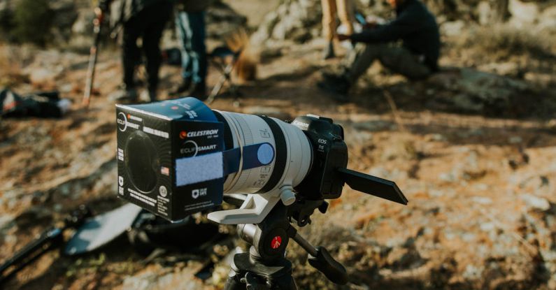 Transmission Filter - A camera on a tripod with people standing around