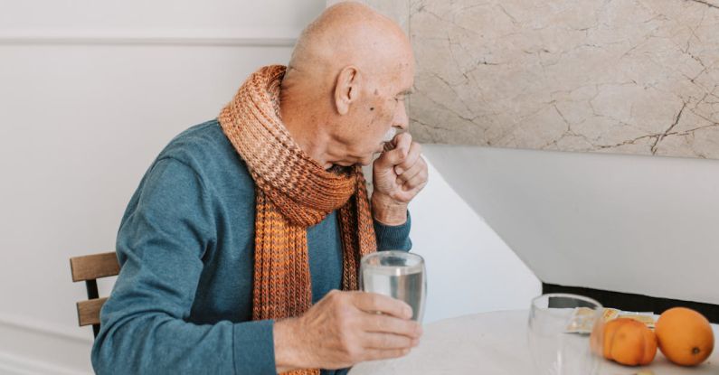 Muffler - A Man in Blue Long Sleeve Shirt Holding a Glass of Water