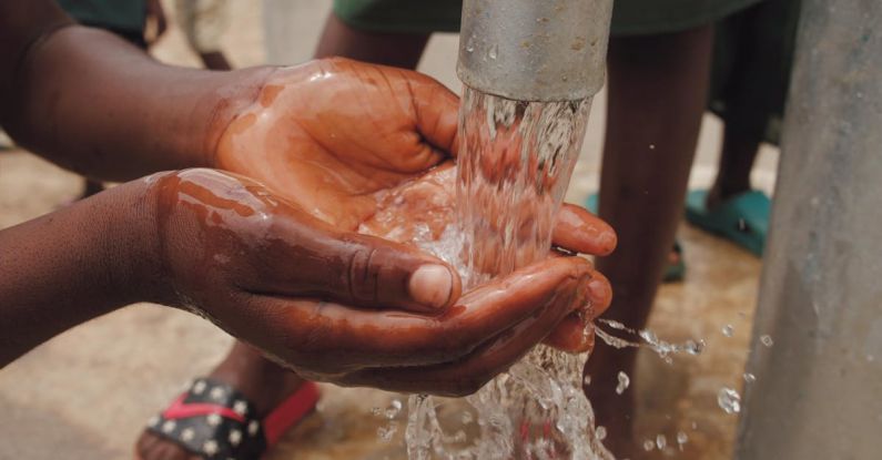 Water Pump - Close-up Of A Child's Hands Catching Water From The Spout Of A Water Pump