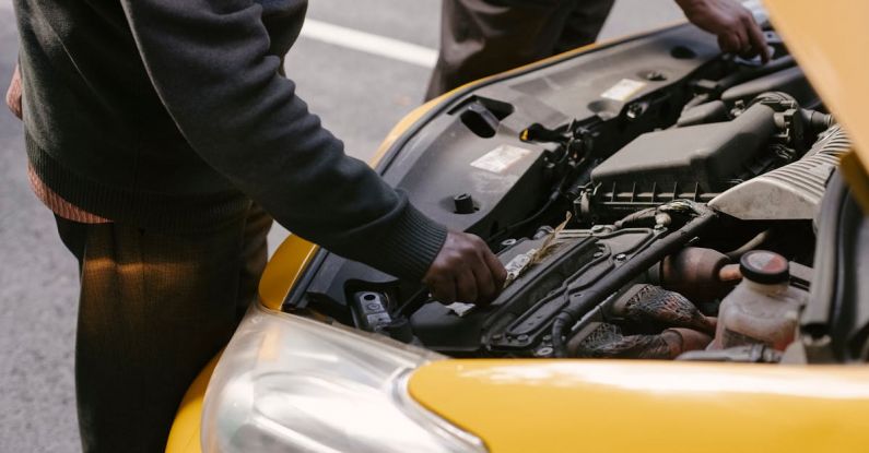 Radiator Hoses - From above side view of crop anonymous ethnic male cab drivers revising modern vehicle bonnet on asphalt roadway