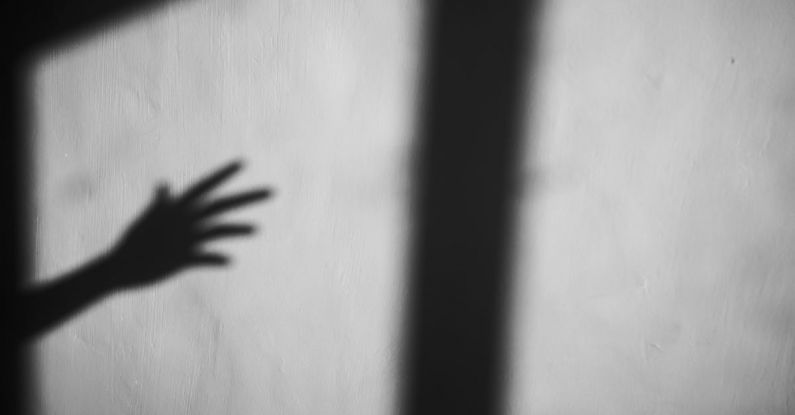 Window Tint - Shadow of crop arm and window frame on gray wall