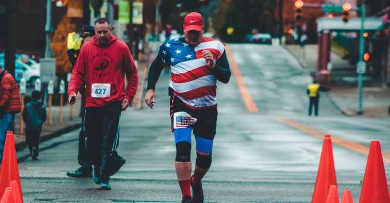 Running Lights - Man Walking on Gray Cement Road Between Traffic Cones