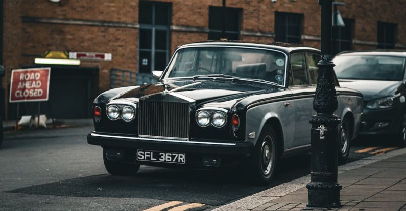 Xenon Headlights - A classic rolls royce parked on the side of the road